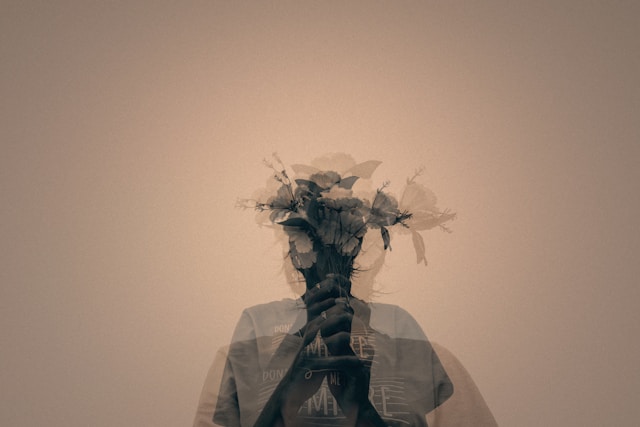 Double exposure of person holding flowers symbolizing depression and hidden emotions