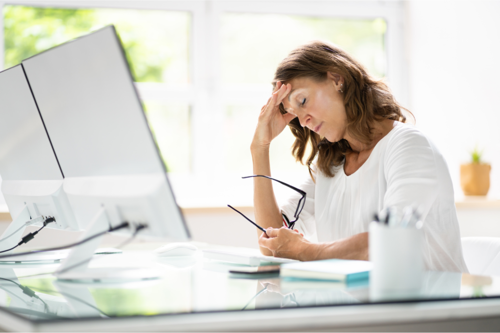 Woman at desk with work stress burnout