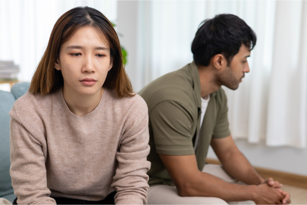Couple with backs to one another upset