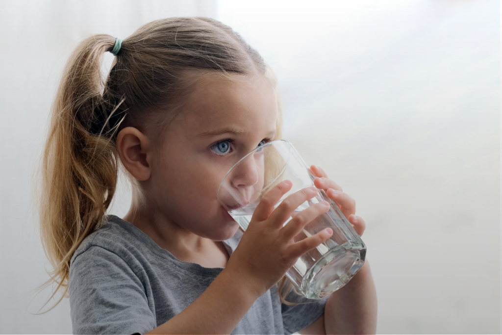 Anxious child drinking water at bedtime