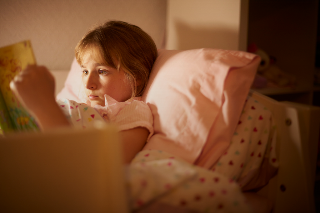 Child reading in bed